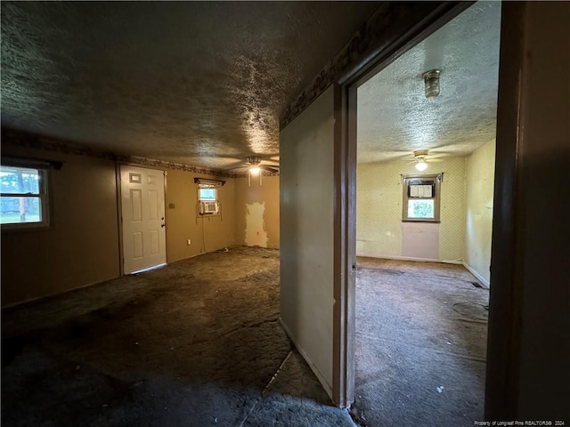 interior space featuring ceiling fan and a textured ceiling