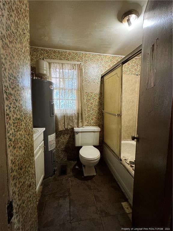 full bathroom with bath / shower combo with glass door, toilet, tile patterned flooring, vanity, and water heater