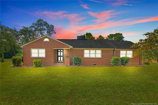 ranch-style house with a lawn