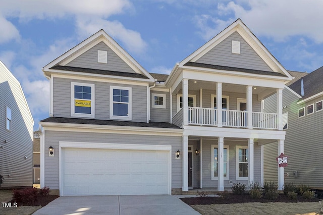 view of front of property with a porch, a balcony, and a garage