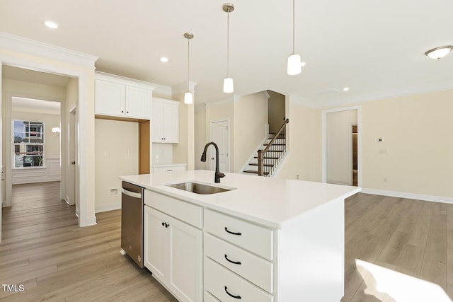 kitchen with dishwasher, hanging light fixtures, an island with sink, white cabinets, and sink