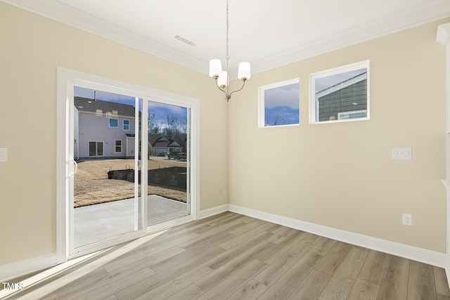 interior space featuring light hardwood / wood-style floors, crown molding, and a chandelier