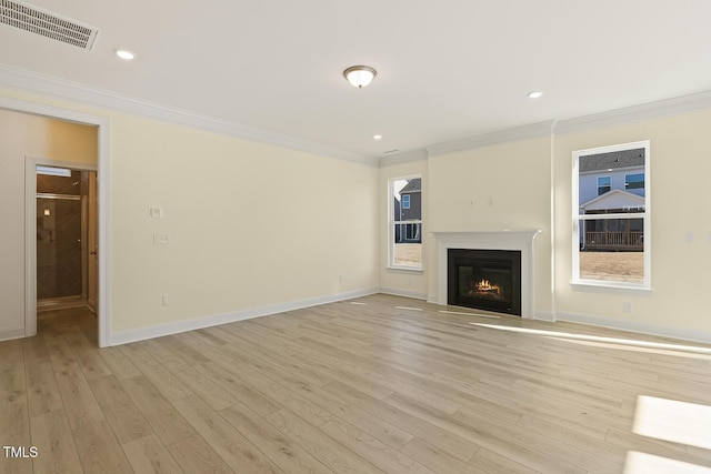 unfurnished living room featuring light wood-type flooring and crown molding