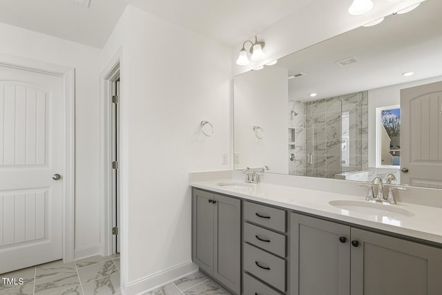 bathroom with a shower with door and vanity