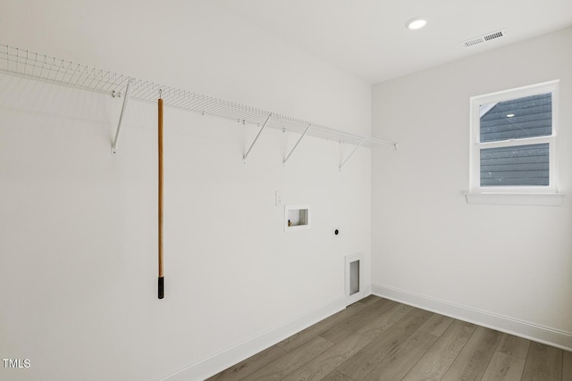 clothes washing area featuring washer hookup, hardwood / wood-style floors, and electric dryer hookup