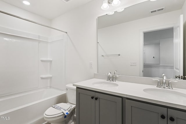 full bathroom featuring shower / bathtub combination, vanity, and toilet