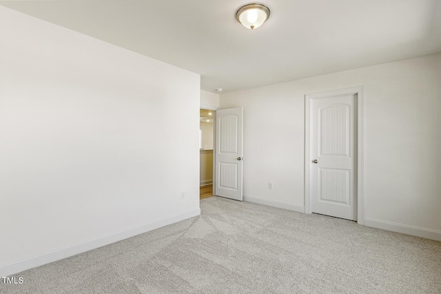 unfurnished bedroom featuring a closet and light carpet