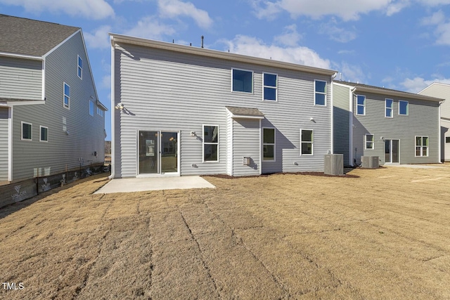 rear view of property with central AC and a patio