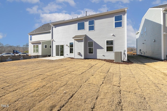 rear view of house featuring a patio and cooling unit