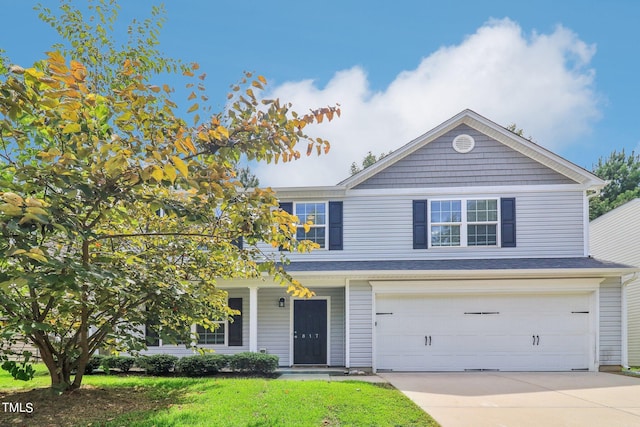 view of front of property with a garage and a front lawn