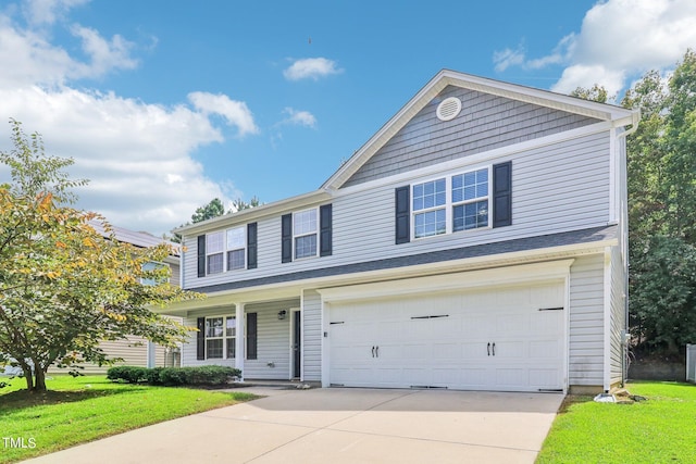 view of front of house with a garage and a front yard