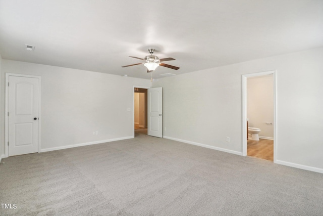 unfurnished room with ceiling fan and light carpet