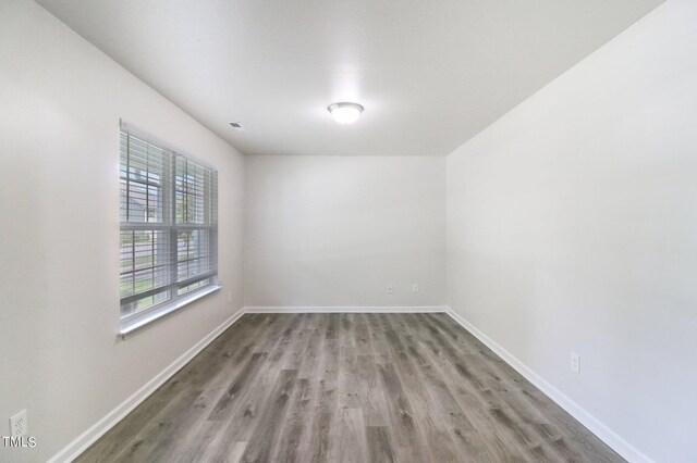 empty room with hardwood / wood-style floors