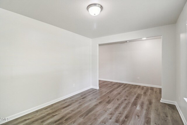 unfurnished room featuring wood-type flooring