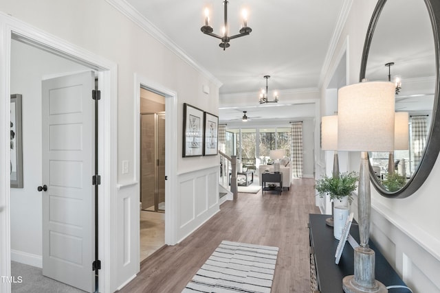 foyer entrance featuring stairs, crown molding, and wood finished floors