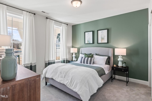 bedroom with carpet, visible vents, and baseboards