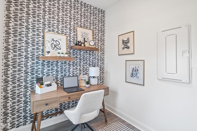 home office with baseboards and wood finished floors