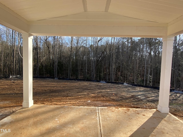 view of patio / terrace featuring a wooded view