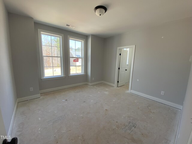 empty room featuring visible vents and baseboards