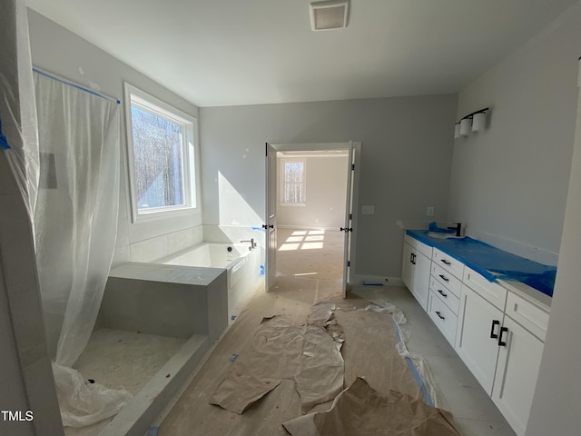 bathroom with curtained shower, a healthy amount of sunlight, visible vents, and a bath