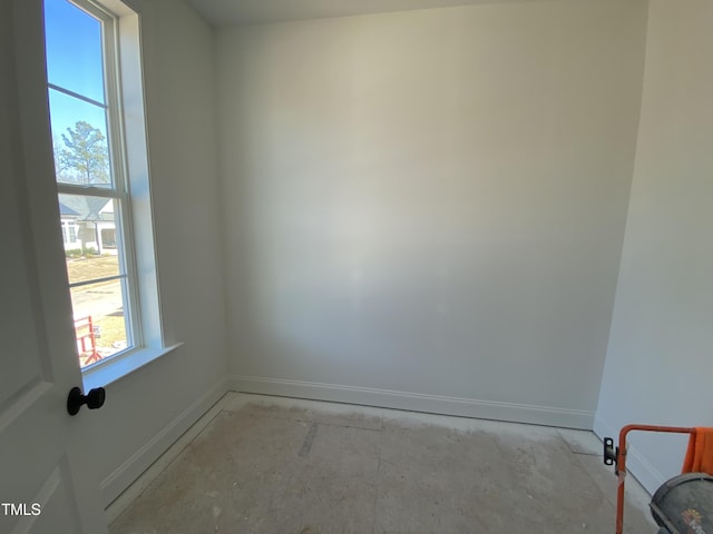 spare room featuring baseboards