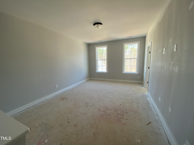 unfurnished room featuring baseboards