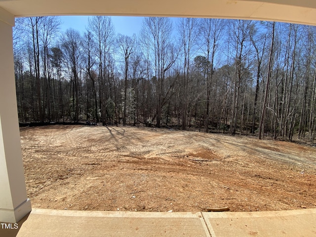 view of yard featuring a view of trees