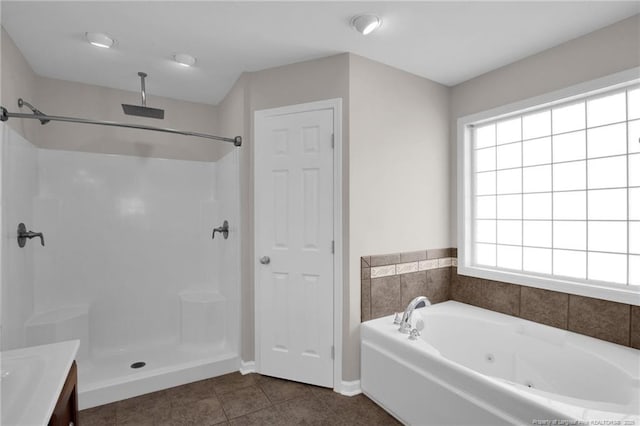 full bath featuring a walk in shower, tile patterned flooring, vanity, and a bath