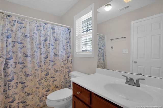 bathroom featuring curtained shower, visible vents, vanity, and toilet