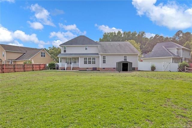 rear view of property with crawl space, a fenced backyard, a lawn, and a storage shed