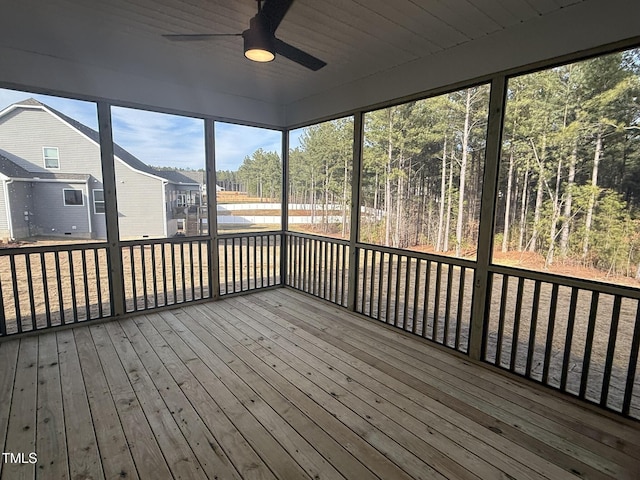 unfurnished sunroom featuring ceiling fan