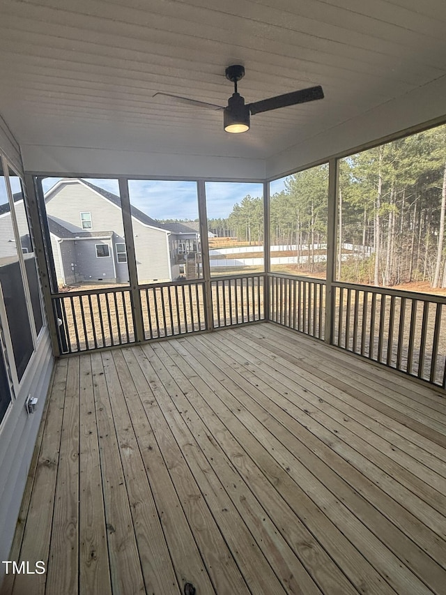 unfurnished sunroom featuring a ceiling fan