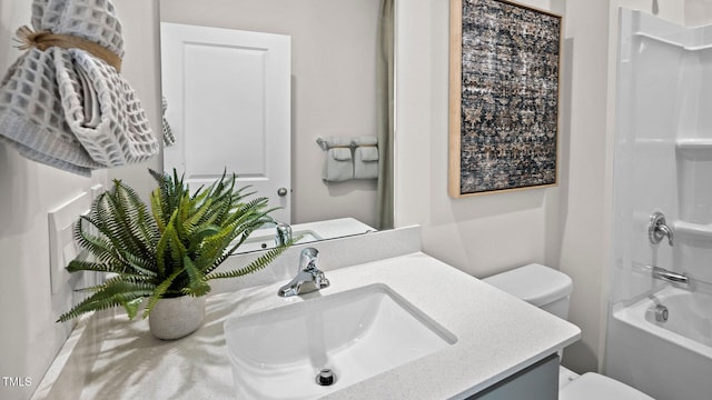 full bath featuring washtub / shower combination, toilet, and vanity