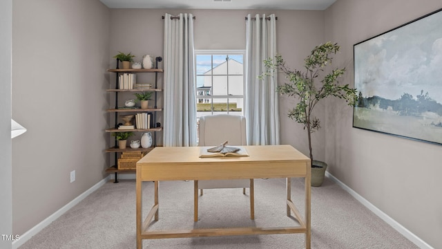 office space with baseboards and light colored carpet