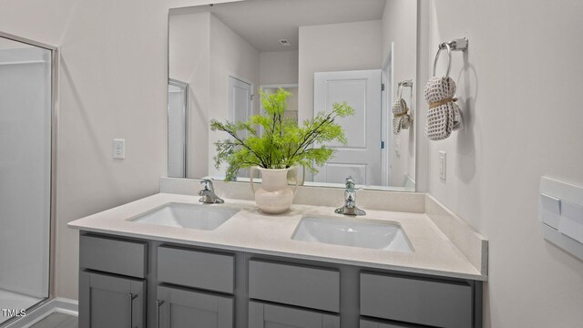 bathroom featuring walk in shower and vanity