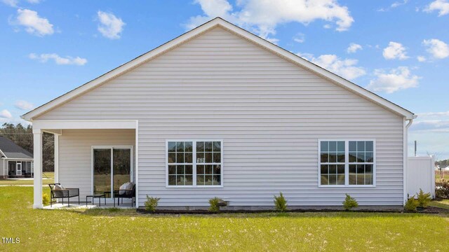 rear view of property with a patio and a yard