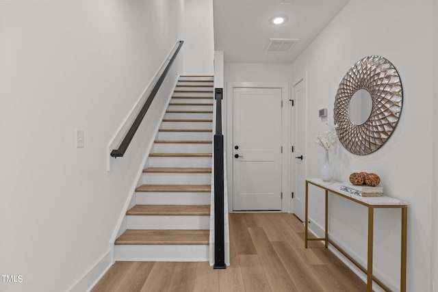 stairs with hardwood / wood-style flooring