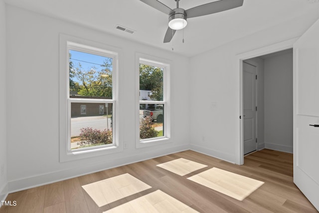 empty room featuring ceiling fan and light wood-type flooring