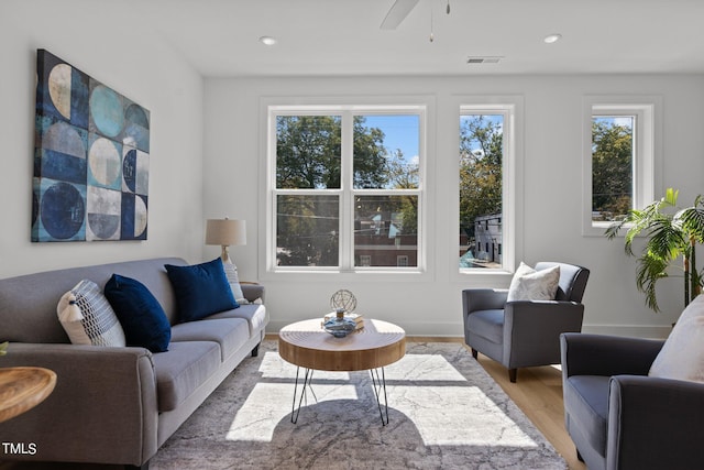 living room featuring ceiling fan and light wood-type flooring