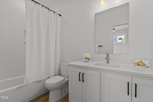 full bathroom with vanity, toilet, shower / bath combo with shower curtain, and hardwood / wood-style flooring