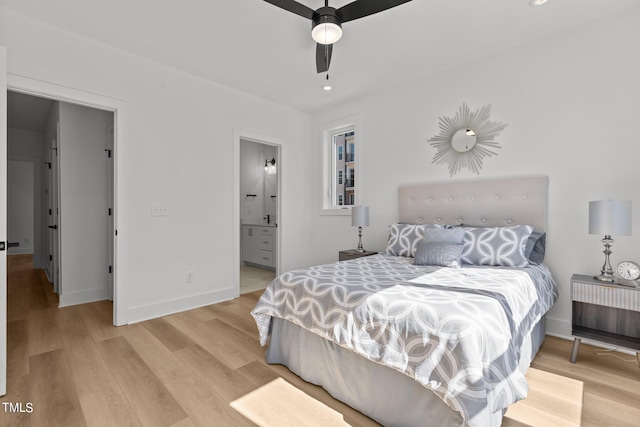 bedroom with ensuite bathroom, ceiling fan, and light hardwood / wood-style floors