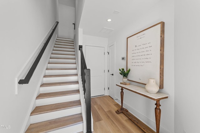 stairs with wood-type flooring