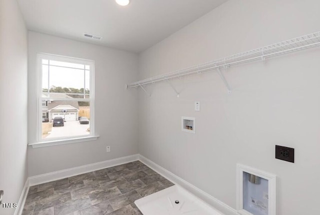 clothes washing area featuring hookup for a washing machine, laundry area, visible vents, baseboards, and electric dryer hookup