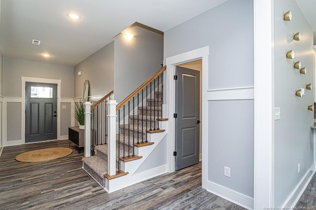 entryway with visible vents, baseboards, stairway, and wood finished floors
