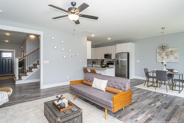 living area with stairway, recessed lighting, baseboards, dark wood finished floors, and a ceiling fan