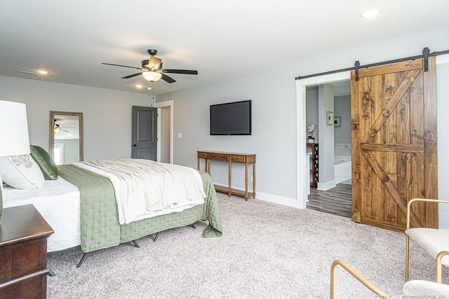 carpeted bedroom with connected bathroom, a ceiling fan, a barn door, baseboards, and recessed lighting