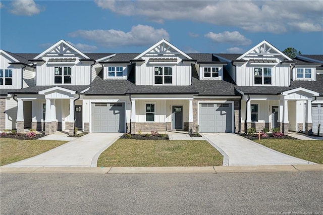 view of front of home with stone siding, board and batten siding, a front yard, and a porch