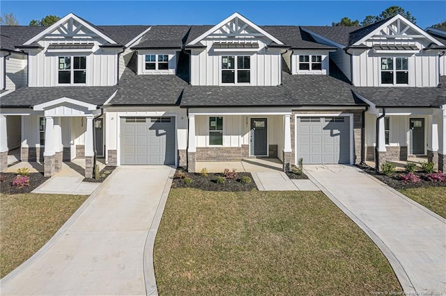 view of front of home with driveway, a front lawn, and board and batten siding