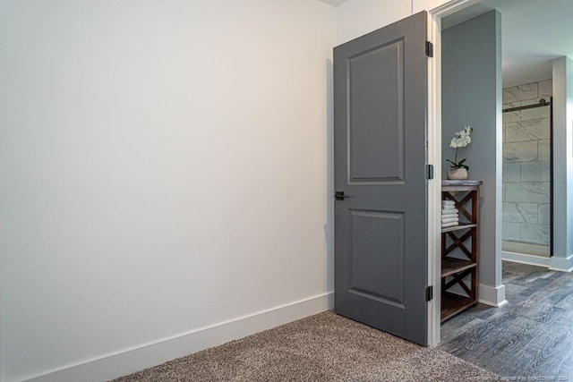 interior space featuring dark wood finished floors and baseboards