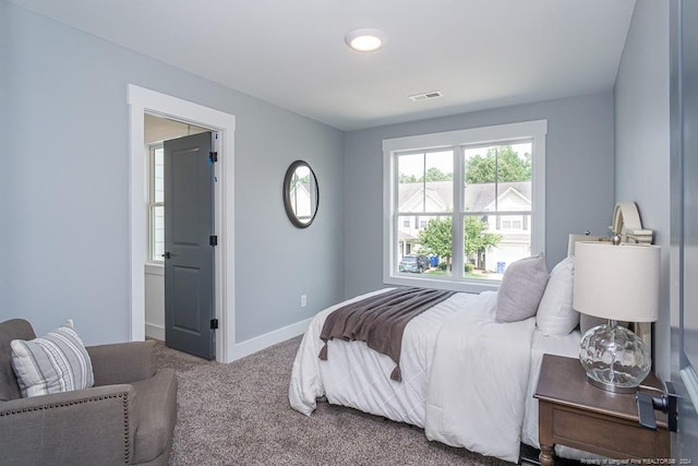 carpeted bedroom with baseboards and visible vents